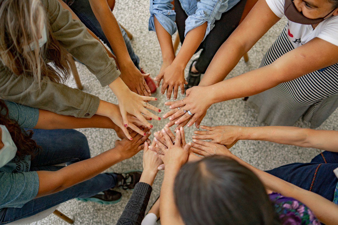 People joining hands in a circle